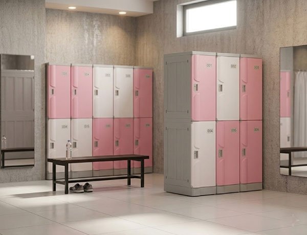 Pink and white ABS plastic lockers on 80mm raised bases in a wet room changing area with bench seating
